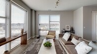 Located at 20 W Northwest Hwy in Mount Prospect, IL, this contemporary single-floor residence offers a thoughtfully designed open-concept layout with modern finishes throughout. The kitchen is a standout feature, outfitted with bold dark cabinetry, white subway tile backsplash, light countertops, and a full suite of stainless steel appliances including a refrigerator, range, microwave, and dishwasher. Light wood-style flooring flows through the kitchen and living areas, lending warmth and continuity to the space. The living room is bright and inviting, with large windows that fill the room with natural light and provide views of the surrounding area. The adjacent dining area opens directly onto a private balcony through sliding glass doors, offering pleasant outdoor views. The two bedrooms are finished with plush carpeting and neutral gray walls. One bedroom includes a walk-in closet, while another features a window with exterior views. Both bathrooms are elegantly appointed with dark cabinetry, dual-sink vanities, white countertops, large framed mirrors, and wood-style flooring, creating a clean and functional aesthetic. The overall design of this residence balances contemporary style with practical livability.