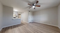 Located at 200 Primrose Cir in New Braunfels, TX, this efficiently designed one-bedroom, one-bathroom unit offers a clean, modern aesthetic throughout its single floor. Light wood-look flooring runs continuously across all rooms, creating a cohesive and bright atmosphere. The open living and dining area is anchored by a ceiling fan with light fixture and provides easy access to the kitchen, making the layout feel functional and connected.

The kitchen is a standout feature, showcasing gray shaker-style cabinetry, white quartz countertops, a patterned tile backsplash, stainless steel appliances including a dishwasher and range, and a peninsula with a built-in sink and industrial-style faucet — ideal for both cooking and casual dining.

The bedroom is a comfortable size, featuring a ceiling fan, a window with outdoor views that bring in natural light, and access to two closets, providing ample storage.

The bathroom is well-appointed with gray shaker vanity cabinetry, a white quartz countertop, and a tub-shower combination finished in white subway tile with a decorative patterned tile accent border and matte black fixtures, adding a stylish contrast. The overall design palette of neutral grays and whites gives the entire space a clean, contemporary feel.