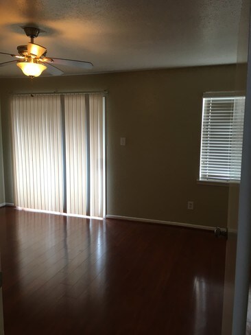 bedroom 1 with balcony and ceiling fan - 3901 Woodchase Dr