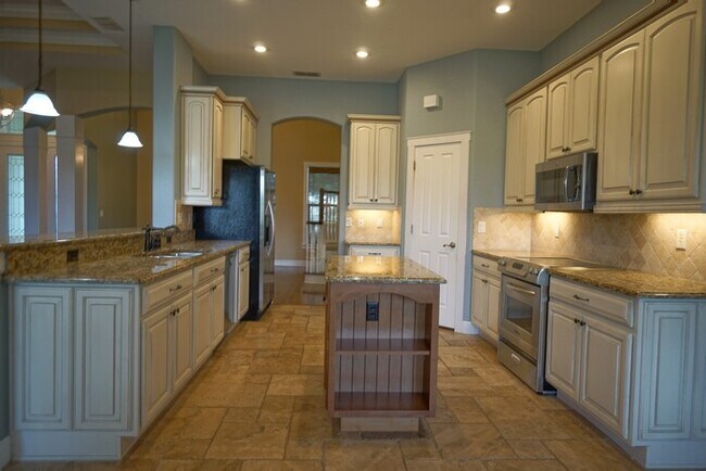 Building Photo - 4-bedroom, 3-bath and 3.5-car garage on pond