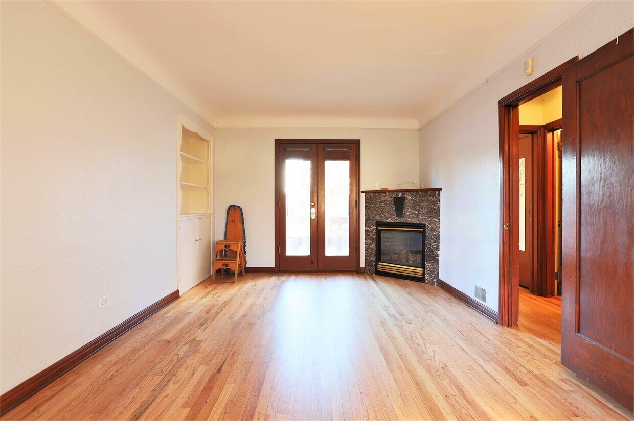 Entertain in the living area highlighted with a cozy fireplace! - 2409 S Lafayette St