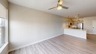 This contemporary 850 square foot apartment in Cedar Rapids, Iowa offers a thoughtfully designed living space. The open-concept floor plan seamlessly integrates the kitchen and living area, creating a spacious feel. The kitchen is a highlight, boasting white cabinetry, quartz countertops, and a full suite of stainless steel appliances, including a refrigerator, range, microwave, and dishwasher.

The bedroom, measuring 130 square feet, features plush carpeting and a large window that floods the space with natural light. The bathroom is modern and functional, with a vanity sink, toilet, and a combination tub-shower. An in-unit laundry room with stacked Samsung washer and dryer adds convenience.

Throughout the apartment, you'll find modern touches like ceiling fans, recessed lighting, and roller shades. The flooring is a mix of sleek wood-look laminate in the main living areas and soft carpeting in the bedroom. Large windows in both the bedroom and living area offer city views.

The efficient layout includes a hallway connecting all rooms, ensuring easy navigation of the space. With its blend of style and functionality, this apartment is an ideal urban dwelling for those seeking a contemporary living experience in Cedar Rapids.