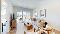 Located at 4 N Hickory Ave in Arlington Heights, IL, this thoughtfully designed one-bedroom, one-bathroom residence offers a contemporary open-concept layout on a single floor. Light wood flooring flows throughout, tying the living spaces together cohesively.

The kitchen is a standout feature, showcasing two-tone cabinetry with navy lower cabinets and natural wood uppers, white quartz countertops, stainless steel appliances, and an island with seating beneath a striking black metal pendant light. The kitchen opens seamlessly into the combined dining and living area, which is bathed in natural light from large sliding glass doors leading to a private balcony overlooking the surrounding Arlington Heights streetscape.

The bedroom is a serene retreat with a large picture window framing outdoor views and providing abundant natural light. Two closets offer generous storage. The bathroom is finished with clean white tile surrounding a full soaking tub and shower combination. An in-unit laundry area adds everyday convenience. The entrance welcomes with a practical layout that flows naturally into the main living spaces. Overall, the residence presents a clean, modern aesthetic with warm natural tones and well-considered finishes throughout.