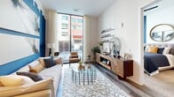 Located at 777 Memorial Dr in Atlanta's dynamic Grant Park neighborhood, this thoughtfully designed one-bedroom, one-bathroom residence offers a modern urban living experience on a single floor. The open-concept kitchen and living area serves as the heart of the home, showcasing light wood cabinetry, a gray subway tile backsplash, stainless steel appliances, and a sleek white quartz island with bar seating beneath striking pendant lights. Wood-style flooring runs throughout the main living areas, adding warmth and continuity. The living room is bathed in natural light from expansive floor-to-ceiling windows that frame urban views and connect the interior to the energy of the street below. A bold blue accent wall with a dramatic cityscape silhouette adds a distinctive artistic touch to the space. The bedroom continues the floor-to-ceiling window theme, offering abundant natural light and a serene retreat enhanced by a cool blue accent wall. The bathroom features a glass-enclosed shower and stylish dark-paneled doors that echo throughout the unit. Additional conveniences include an in-unit laundry area, a utility room, and a dedicated closet, making this residence as functional as it is visually compelling.