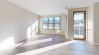 Located on the 7th floor at 538 Bond Ave NW in Grand Rapids, Michigan, this one-bedroom, two-bathroom residence offers a thoughtfully designed open-concept layout. The combined living, dining, and kitchen area is anchored by light hardwood-style flooring and large windows that flood the space with natural light and frame views of the surrounding cityscape. A private balcony extends the living area outdoors, accessible directly from the main living space.

The kitchen is well-appointed with warm wood cabinetry, dark granite countertops, stainless steel appliances including a refrigerator, range, and over-the-range microwave, and a peninsula with additional counter space for dining or food prep. Track lighting above the kitchen adds functional illumination.

The spacious primary bedroom features a large window with urban views, light hardwood-style flooring, and generous closet space supported by four closets throughout the unit, including a walk-in with wire shelving. The full bathroom includes a soaking tub with decorative tile surround, slate-style floor tile, warm wood vanity, and dark granite countertops. A second bathroom provides additional convenience. The unit's clean, neutral palette and modern finishes create a bright, cohesive living environment throughout.