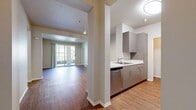 This contemporary apartment, located at 8200 Haven Avenue in Rancho Cucamonga, offers 1090 square feet of thoughtfully designed living space. The single-story layout includes three bedrooms and three full bathrooms, providing ample privacy for residents and guests. The heart of the home is an open-concept living and dining area, featuring warm wood-look flooring and abundant natural light from large sliding glass doors that lead to an outdoor patio.

The kitchen boasts modern gray cabinetry, stainless steel appliances, and a convenient breakfast bar, perfect for casual dining or entertaining. Each bedroom is carpeted for comfort, with the primary bedroom measuring a spacious 160 square feet. The bathrooms are equipped with crisp white fixtures and tiled surrounds, while some feature wood-look flooring for a touch of warmth.

Practical amenities include an in-unit laundry room with a full-size washer, and multiple closets throughout for storage. The apartment's neutral color palette and clean lines create a blank canvas for personal decoration. Large windows in the bedrooms and living areas flood the space with natural light, enhancing the sense of openness. This well-appointed apartment offers a perfect blend of style, comfort, and functionality in a desirable Rancho Cucamonga location.