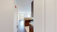 Located at 330 Jacksonville Road in Warminster, PA, this one-bedroom, one-bathroom residence offers a well-organized, single-floor layout designed for comfortable everyday living. The open-concept kitchen and living area serves as the heart of the home, where rich espresso-toned cabinetry pairs with granite countertops and a full suite of stainless steel appliances, including a refrigerator, electric range, and built-in microwave. A peninsula with seating provides both additional prep space and a casual dining option. Light-toned tile flooring runs through the kitchen, while durable hardwood-style flooring extends throughout the living area, adding warmth and continuity. Natural light flows in through multiple windows, including a glass door in the kitchen that brightens the space. The bedroom is generously proportioned, featuring plush carpeting, a large window with outdoor views, and direct access to a dedicated closet. The full bathroom is clean and functional, appointed with a tub/shower combination and tile flooring. Neutral wall tones and crisp white trim throughout lend the residence a bright, move-in-ready aesthetic that is both practical and inviting.