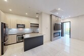 Located at 229 Waterman Street in Providence, Rhode Island, this thoughtfully designed one-bedroom, one-bathroom residence offers a refined contemporary living experience across a single floor. Large-format porcelain tile flooring runs throughout the main living areas, lending a clean, cohesive aesthetic that enhances the sense of openness.

The modern kitchen is a standout feature, equipped with light wood flat-panel cabinetry, stainless steel appliances including a built-in oven, microwave, and French door refrigerator, a textured tile backsplash, and a central island with a quartz countertop that provides additional prep and dining space.

The spacious primary bedroom is accessed through a sleek dark-wood door with metal inlay detailing — a design element repeated throughout the unit for visual consistency. The room includes a double-door closet and continues the large-format tile flooring.

The bathroom features warm travertine-style tile flooring, a wood-toned floating vanity with an integrated sink, and textured wall tile, creating a spa-like atmosphere.

A private outdoor balcony finished with light hardwood decking and glass railing panels opens to elevated views of the Providence cityscape. The exterior features a striking vertical wood-panel facade, adding architectural character. This residence combines modern design with functional urban living.