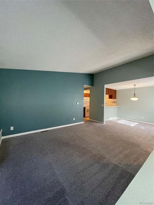 Living room view of the dining room and kitchen - 6700 E Mississippi Ave