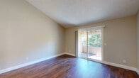 This single-story, 3-bedroom, 3-bathroom home in Citrus Heights, CA offers a well-organized layout designed for comfortable everyday living. The living room features warm wood-look flooring, soaring ceilings, and a sliding glass door that opens to a private outdoor patio, filling the space with natural light and providing a seamless indoor-outdoor connection. A standout built-in shelving and desk unit adds both character and function to the area.

The kitchen is appointed with rich wood cabinetry, stainless steel appliances including a refrigerator, range, and microwave, a mosaic tile backsplash, and a generous white quartz peninsula with an undermount sink — ideal for meal prep and casual dining.

The three bedrooms are carpeted for comfort and feature closets and ample wall space. Vaulted ceilings in select rooms contribute to an open, airy feel. Hallways connect the bedrooms to the bathrooms, which are well-appointed with wood-toned vanities, white quartz countertops, and wood-look flooring. One bathroom features a tub-shower combo, while another offers a walk-in shower with glass sliding doors. The overall aesthetic throughout the home is clean, neutral, and move-in ready.
