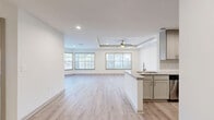 Located at 1970 Peachford Rd in Dunwoody, GA, this 2-bedroom, 1-bathroom single-floor residence offers a well-designed layout that maximizes functionality and comfort. The heart of the home is an open-concept living, dining, and kitchen area that flows seamlessly together. The kitchen is outfitted with sage-toned shaker cabinets, granite countertops, a subway tile backsplash, stainless steel appliances, and a peninsula with a sink — ideal for both cooking and casual dining. Light hardwood-style flooring runs throughout the entire home, lending a clean and cohesive aesthetic. The expansive living area features a distinctive tray ceiling with a ceiling fan and is lined with multiple windows that allow abundant natural light and outdoor views. Both bedrooms continue the tray ceiling detail and ceiling fan fixtures, with the primary bedroom offering corner windows on two walls for enhanced light and views. The second bedroom is bright and well-proportioned. The bathroom includes a soaking tub and a separate walk-in shower, both fully tiled in white subway tile. Additional highlights include four closets — providing generous storage — a dedicated pantry, in-unit laundry, and a hallway connecting the private areas of the home.