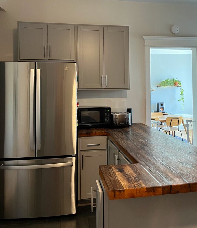 The kitchen also has a roomy fridge with an ice maker and filtered water. - 5142 S Greenwood Ave