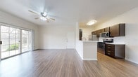 Located at 1900 Aquarena Springs Dr in San Marcos, TX, this single-story, 3-bedroom, 1-bathroom home offers a functional and comfortable layout across a well-utilized floor plan. The open-concept living area features warm wood-look flooring, crown molding, and a ceiling fan, creating a bright and airy atmosphere. The kitchen is equipped with dark espresso cabinetry, stainless steel appliances including a gas range, microwave, refrigerator, and dishwasher, along with a classic subway tile backsplash and a peninsula counter that connects seamlessly to the dining and living areas. Three bedrooms provide comfortable accommodations, with the primary bedroom offering a generous footprint. The bedrooms feature plush carpeting and ample closet space, with four closets distributed throughout the home. A dedicated laundry area with washer/dryer hookups adds everyday convenience. The single full bathroom serves the household efficiently. A private patio extends the living space outdoors, overlooking a serene open green landscape dotted with mature trees — ideal for relaxing or enjoying the Texas scenery. The home also includes a separate dining area and additional storage throughout.