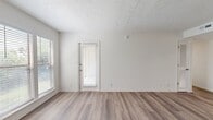 This 880-square-foot, single-story apartment at 1600 Nesbitt Lane in Nashville, TN offers 2 bedrooms and 2 bathrooms across a well-designed, functional layout. Throughout the unit, durable hardwood-style flooring and crisp white walls create a clean, modern aesthetic. The open living room serves as the heart of the home, featuring a tile-surround fireplace, a textured ceiling, and large windows that invite abundant natural light. It flows seamlessly into the galley-style kitchen, which is equipped with gray shaker cabinets, marble-look countertops, a skylight, and black stainless steel appliances including a range, microwave, refrigerator, and dishwasher. The primary bedroom spans 190 square feet and includes a ceiling fan, windows with outdoor views, and access to a dedicated closet. The second bedroom also features a ceiling fan and its own closet. Both bathrooms are finished with white tub-shower combinations, brushed nickel fixtures, and vanities with marble-style countertops. A hallway connects the two bedrooms and bathrooms, with additional closet storage available. The unit's bright, neutral palette and updated finishes make it a functional and comfortable home in Nashville.