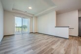 This thoughtfully designed single-floor residence offers three bedrooms, two bathrooms, and a functional layout that maximizes everyday living. The open-concept kitchen and living area serves as the heart of the home, showcasing rich wood cabinetry, granite countertops, a central island with pendant lighting overhead, and a full suite of stainless steel appliances — including a refrigerator, range, and built-in microwave. Light wood-style flooring runs throughout the main living areas, lending warmth and cohesion to the space.

The bedrooms are comfortably sized, with the primary bedroom offering generous proportions, a tray ceiling, carpeted flooring, and access to a walk-in closet outfitted with wire shelving systems for ample storage. Additional bedrooms also feature carpet and natural light from well-placed windows. The bathrooms are finished with granite-topped vanities, dark wood cabinetry, tile flooring, and a full tub-shower combination with chrome fixtures.

A dedicated laundry room includes side-by-side washer and dryer units with additional wire shelving above. Carpeted stairs with a metal handrail connect the levels, and the overall aesthetic throughout is clean and contemporary with neutral tones.
