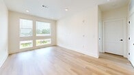 Located at 1200 Foster St NW in Atlanta's vibrant West Midtown neighborhood, this well-appointed two-bedroom, two-bathroom residence offers a thoughtfully designed single-level layout. Light hardwood flooring flows seamlessly throughout, creating a cohesive and airy feel across every room.

The kitchen serves as the heart of the home, boasting a large center island with a dark granite countertop, pendant lighting, crisp white cabinetry, stainless steel appliances, and a striking dark subway tile backsplash — a clean contrast that adds modern character.

Both bedrooms are bright and inviting, each featuring large windows that frame natural greenery and allow abundant natural light to fill the space. Each bedroom is paired with a dedicated walk-in closet outfitted with wire shelving systems for organized storage.

The primary bathroom features a frameless glass-enclosed shower, dark granite countertops atop white vanity cabinetry, and direct access to a spacious walk-in closet. The second bathroom mirrors the same contemporary aesthetic with a large vanity, dark countertop, and a tub-shower combination. Black hardware accents throughout both bathrooms tie the design together with a refined, modern touch.