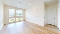 Located at 1200 Foster St NW in Atlanta's vibrant West Midtown neighborhood, this well-appointed two-bedroom, two-bathroom residence offers a thoughtfully designed single-level layout. Light hardwood flooring flows seamlessly throughout, creating a cohesive and airy feel across every room.

The kitchen serves as the heart of the home, boasting a large center island with a dark granite countertop, pendant lighting, crisp white cabinetry, stainless steel appliances, and a striking dark subway tile backsplash — a clean contrast that adds modern character.

Both bedrooms are bright and inviting, each featuring large windows that frame natural greenery and allow abundant natural light to fill the space. Each bedroom is paired with a dedicated walk-in closet outfitted with wire shelving systems for organized storage.

The primary bathroom features a frameless glass-enclosed shower, dark granite countertops atop white vanity cabinetry, and direct access to a spacious walk-in closet. The second bathroom mirrors the same contemporary aesthetic with a large vanity, dark countertop, and a tub-shower combination. Black hardware accents throughout both bathrooms tie the design together with a refined, modern touch.