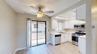 Located at 3850 Skofstad St in Riverside, California, this single-story unit offers a practical and well-maintained layout encompassing a living room and one bedroom. The interior features light-toned luxury vinyl plank flooring throughout, complementing the neutral beige and gray wall palette and textured ceilings that lend a clean, consistent aesthetic across all rooms.

The living room is generously proportioned, benefiting from a sliding glass door that invites natural light and provides outdoor views. A ceiling fan adds comfort to the space, while the open sightline toward the kitchen area enhances the sense of connectivity throughout the unit.

The bedroom is comfortably sized and includes a large sliding-door closet for ample storage, along with a secondary closet nearby. A window overlooking the surrounding greenery fills the room with natural light, creating a bright and airy feel. Clean white trim and baseboards run throughout, adding a crisp contrast to the warm neutral walls.

The bathroom is accessible from the hallway and appears well-lit with functional fixtures. Overall, the unit presents a move-in ready interior with consistent finishes, efficient use of space, and a calm, neutral ambiance suited to a variety of lifestyles.