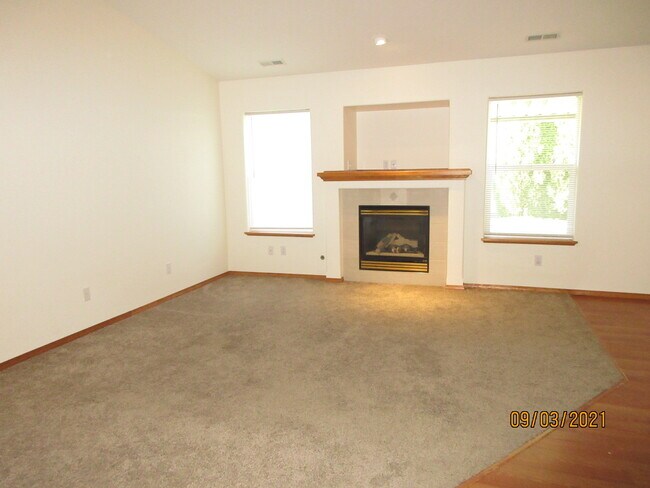 living room with gas fireplace - 18425 E Sprague Ave