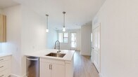 Located at 5415 Alamo Parkway in San Antonio, TX, this thoughtfully designed one-bedroom, one-bathroom residence offers a clean, modern aesthetic across a single floor. Light wood-look flooring flows seamlessly throughout, creating a cohesive and bright atmosphere.

The open-concept kitchen is a standout feature, equipped with stainless steel appliances including a French door refrigerator, electric range, built-in microwave, and dishwasher. Flat-panel cabinetry in a warm wood tone is paired with crisp white lower cabinets and white quartz countertops. A kitchen island with an undermount sink and pendant lighting above adds both functionality and style, while recessed lighting illuminates the space efficiently.

The bedroom is a well-proportioned, serene retreat featuring a window with blinds that allows natural light to filter in. A ceiling fan adds comfort, and direct access to both a closet and the bathroom enhances convenience.

The bathroom is elegantly appointed with a long wood-toned vanity, white quartz countertop, undermount sink, and a well-lit frameless mirror. The space is clean and functional, with light-toned flooring continuing from the rest of the home.

Overall, this residence offers a modern, move-in-ready interior with consistent finishes and a practical layout well-suited for everyday living.