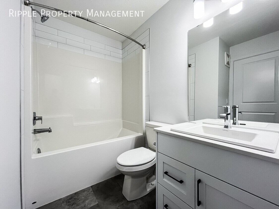 Photo du bâtiment - AMAZING 1 BED BASEMENT SUITE | MODERN LIVING IN THE ORCHARDS