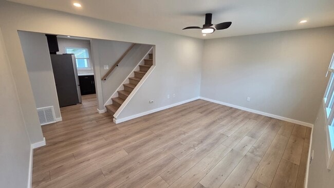 Step inside to a bright and welcoming living room featuring new vinyl plank flooring and sleek LED r - 604 Holly Ln
