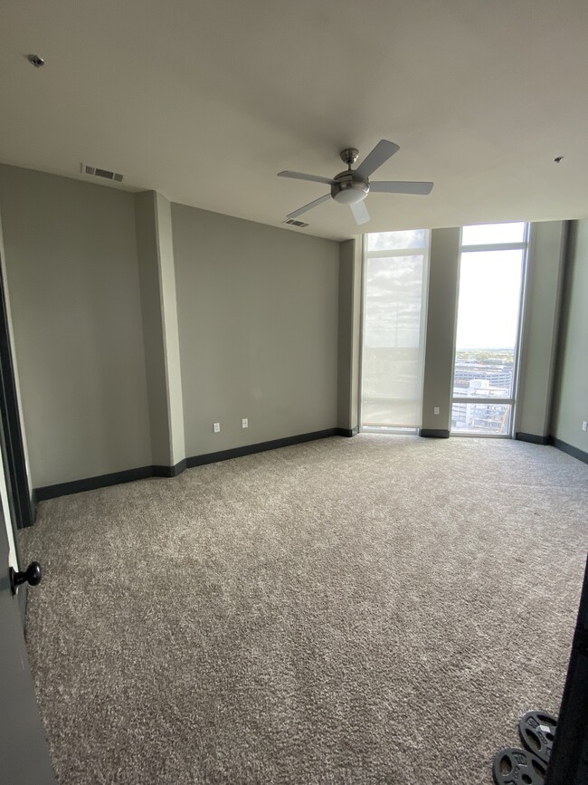 spacious bedroom with a 12 ft city-view window - 100 N Santa Rosa St