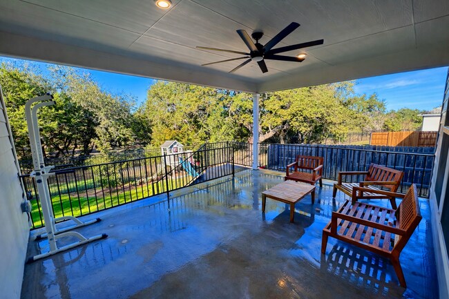 Extended covered back patio with gas hookup for grilling, overlooking a peaceful greenbelt. - 517 Moonlit Stream Pass