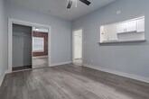 Located in the Koreatown neighborhood of Los Angeles, this single-floor unit at 2810 Leeward Ave blends vintage character with modern updates. Throughout the space, light-toned wood-look flooring creates a cohesive, contemporary feel underfoot.

The kitchen is a standout area, showcasing a striking exposed red brick wall with an arched window detail that adds warmth and architectural interest. It is equipped with white cabinetry, granite-style laminate countertops, a stainless steel double-basin sink, and a gas range, offering a functional and visually appealing cooking space.

Adjacent to the kitchen, the living area is bright and open, featuring a ceiling fan for comfort and clean, neutral-toned walls that create a versatile canvas. Natural light flows in, enhancing the airy feel of the room.

The bathroom is clean and simply appointed, finished in crisp white with a window that allows natural light to brighten the space. Wood-look flooring continues here, maintaining design consistency throughout.

The layout, as seen in the 3D overview, is compact yet well-organized, with clearly defined spaces that flow naturally from one to the next. The combination of exposed brick, updated fixtures, and neutral finishes gives this Los Angeles unit a distinctive character that balances classic charm with contemporary livability.