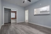 Located in the Koreatown neighborhood of Los Angeles, this single-floor unit at 2810 Leeward Ave blends vintage character with modern updates. Throughout the space, light-toned wood-look flooring creates a cohesive, contemporary feel underfoot.

The kitchen is a standout area, showcasing a striking exposed red brick wall with an arched window detail that adds warmth and architectural interest. It is equipped with white cabinetry, granite-style laminate countertops, a stainless steel double-basin sink, and a gas range, offering a functional and visually appealing cooking space.

Adjacent to the kitchen, the living area is bright and open, featuring a ceiling fan for comfort and clean, neutral-toned walls that create a versatile canvas. Natural light flows in, enhancing the airy feel of the room.

The bathroom is clean and simply appointed, finished in crisp white with a window that allows natural light to brighten the space. Wood-look flooring continues here, maintaining design consistency throughout.

The layout, as seen in the 3D overview, is compact yet well-organized, with clearly defined spaces that flow naturally from one to the next. The combination of exposed brick, updated fixtures, and neutral finishes gives this Los Angeles unit a distinctive character that balances classic charm with contemporary livability.