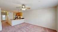This well-designed townhome on Tartuffe Drive in Henrico, Virginia offers 1160 square feet of living space across two floors. The ground floor spans 520 square feet, while the upper level provides 640 square feet of space. The home features three bedrooms, including a spacious primary bedroom of 160 square feet, and three full bathrooms.

The kitchen is a standout feature, boasting honey-toned wooden cabinets, stainless steel appliances, and elegant dark countertops. Track lighting illuminates the workspace, while a breakfast bar offers casual dining and additional prep space. The living area seamlessly connects to the kitchen, creating an open-concept feel ideal for entertaining.

Throughout the home, plush carpeting in a soft pink hue adds warmth and comfort to the bedrooms and living spaces. Large windows in each room allow ample natural light, enhancing the airy atmosphere. Ceiling fans in select rooms provide additional comfort and air circulation.

The bathrooms are appointed with modern fixtures, including a combination tub-shower in at least one bathroom, and stylish tile work. Built-in closets in the bedrooms offer practical storage solutions.

The property's neutral color palette, primarily whites and creams, creates a blank canvas for personalization. With its thoughtful layout and contemporary amenities, this townhome presents a comfortable and functional living space in a desirable Henrico location.