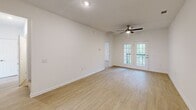 Located at 2109 Oglethorpe Cir in Pooler, GA, this two-story home offers three bedrooms and three full bathrooms across two thoughtfully designed floors. The main floor features a bright, open living room with light wood-look flooring, a ceiling fan, and French doors that invite natural light and provide outdoor access. An elegant arched doorway connects the living area to the rest of the home, lending a classic architectural touch. The well-appointed kitchen features gray shaker-style cabinetry, crisp white quartz countertops, a white subway tile backsplash, stainless steel appliances, and a window above the sink. Each bathroom is finished with gray vanity cabinetry, white countertops, and brushed nickel fixtures, maintaining a clean and consistent aesthetic. The bedrooms feature plush carpet flooring and ceiling fans. The primary bedroom, located on the upper floor, impresses with vaulted ceilings and multiple windows that frame views of the surrounding greenery, creating an airy, private retreat. Additional bedrooms on the main floor offer ample natural light through dual windows. Hallways and staircases connect both levels seamlessly, completing this well-organized and move-in-ready home.