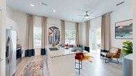 Located at 3025 Woodward Crossing Boulevard in Buford, GA, this 1-bedroom, 1-bathroom residence offers a thoughtfully designed open-concept layout that maximizes every square foot. The living area impresses with soaring ceilings and floor-to-ceiling windows that flood the space with natural light, complemented by sliding glass doors that open onto a private patio with outdoor views. Light wood-style flooring runs throughout the main living areas, enhancing the bright, airy ambiance.

The kitchen is a standout feature, showcasing crisp white cabinetry that extends to the ceiling for generous storage, gleaming granite countertops, a subway tile backsplash, and a full suite of stainless steel appliances including a refrigerator, range, microwave, and dishwasher. A large center island with an integrated sink and bar seating connects the kitchen seamlessly to the living and dining area.

The bedroom offers plush carpeting, a sunny window, and direct access to a spacious walk-in closet with wire shelving for ample storage. The full bathroom features a granite-topped vanity with white cabinetry, wood-look tile flooring, and a tub-shower combination. A stylish entryway with built-in shelving completes this modern, well-equipped residence.