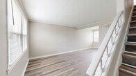 Located at 710 Lone Oak Drive in Paducah, Kentucky, this two-story home offers a practical and thoughtfully designed layout spread across two floors. The main level features a welcoming entrance that flows into a bright living room, highlighted by wood-look laminate flooring, neutral warm-toned walls, crown molding, and a white-railed staircase leading to the upper level. Natural light fills the space through multiple windows fitted with white blinds. The kitchen is well-equipped with rich dark-brown cabinetry, granite-style countertops, a stainless steel gas range, and a single-basin sink — all complemented by a window overlooking the outdoors. The upper floor houses both bedrooms and the full bathroom. Each bedroom features the same wood-look flooring, crown molding, neutral walls, and ample natural light from multiple windows. The primary bedroom includes a dedicated closet. The full bathroom is clean and functional, offering a shower-tub combo, a dark-vanity with a white basin sink, a medicine cabinet mirror, and a bright window. The consistent use of neutral tones, modern fixtures, and wood-look flooring throughout gives the home a cohesive, move-in-ready aesthetic.