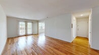 Located at 1714 Plaza Dr in Woodbridge, NJ, this single-level 2-bedroom, 2-bathroom residence offers a thoughtfully laid-out floor plan with a bright, open feel throughout. Rich hardwood flooring runs continuously through the living areas, bedrooms, and hallways, adding warmth and cohesion to the space.

The expansive living area is bathed in natural light thanks to large windows and glass patio doors that open to an outdoor area, creating a seamless connection between interior and exterior. The kitchen is equipped with dark wood cabinetry, stainless steel appliances including a gas range and refrigerator, and light wood-style flooring, offering a functional and well-appointed cooking space.

Both bathrooms are finished with stylish shaker-style vanities featuring granite countertops, framed mirrors, tile flooring, and built-in shelving for added storage. The generously sized primary bedroom receives ample natural light from a dedicated window, while the second bedroom includes a sliding closet for convenient storage. With six closets total and a dedicated laundry room, this residence provides exceptional storage capacity. Clean white walls and consistent finishes throughout give the space a fresh, move-in-ready appeal.