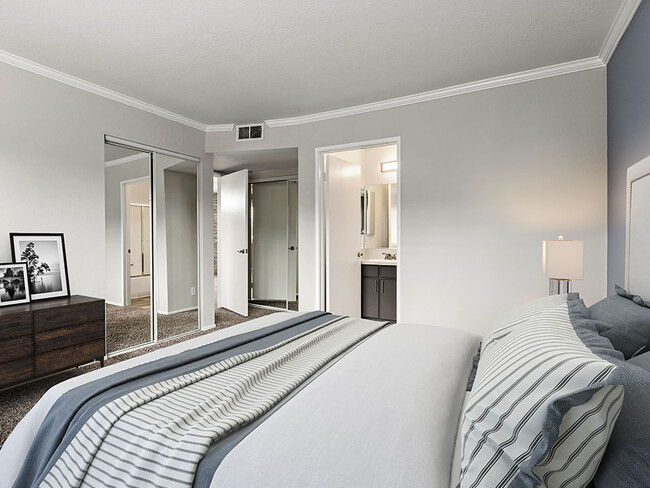 Carpeted bedroom with access to private bathroom. - Magnolia Terrace