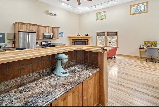 View from bar into kitchen and living area - 100 Thomas Rd