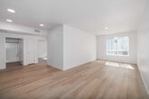 This contemporary single-story residence in San Diego offers a well-designed living space of 940 square feet. The home features five bedrooms, including a generous primary bedroom of 410 square feet, and two full bathrooms. Throughout the property, light wood flooring creates a warm and cohesive aesthetic.

Large windows with vertical blinds are prominent in several rooms, allowing ample natural light to flood the space and offering views of the surrounding area. The bright, airy atmosphere is enhanced by crisp white walls and ceilings, creating a clean, modern ambiance.

The bathrooms are equipped with modern fixtures, including a vanity with storage, a large mirror, and a combination bathtub-shower. Safety features such as grab bars are installed, indicating thoughtful design for accessibility.

The property includes a closet space with built-in shelving, providing practical storage solutions. The kitchen, while not fully visible in the images, appears to be integrated into the open floor plan.

Overall, this home presents a contemporary living space with a focus on functionality and natural light. Its layout and features make it suitable for a variety of living arrangements, from family homes to shared accommodations.