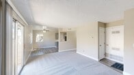 Located at 1180 Matmor Rd in Woodland, CA, this single-story 2-bedroom, 1-bathroom unit offers a well-organized and functional layout. The living room is bright and welcoming, featuring a ceiling fan, a sliding glass door that opens to the outdoors, and a seamless transition between carpet and wood-look vinyl flooring. Natural light flows in through multiple windows, offering views of the surrounding neighborhood greenery.

The combined kitchen and dining area is a functional highlight of the home, showcasing gray shaker-style cabinetry, white quartz countertops, a stainless steel sink, and a full suite of stainless steel appliances including a range and refrigerator. Recessed lighting and wood-look vinyl flooring complete the clean, modern aesthetic of this space.

Both bedrooms are carpeted and feature neutral beige walls, textured ceilings, and windows that bring in ample natural light with outdoor views. The primary bedroom includes closet access, while all bedrooms benefit from the four closets distributed throughout the unit. A hallway connects the main living areas to the bedrooms and bathroom. The entrance provides a convenient transition into the home, and the overall palette of warm neutrals and clean white trim creates a cohesive, move-in-ready ambiance throughout.