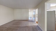 This well-designed apartment offers 790 square feet of comfortable living space across a single floor. The layout includes two bedrooms, one bathroom, and an open-concept kitchen and living area. The primary bedroom is generously sized at 150 square feet, providing ample space for relaxation.

The modern kitchen is a standout feature, boasting crisp white cabinetry, granite countertops, and stainless steel appliances. It opens seamlessly into the living area, which is illuminated by large windows and sliding glass doors, allowing natural light to flood the space.

Throughout the apartment, you'll find a thoughtful mix of flooring materials. The bedrooms and living area are carpeted for comfort, while the kitchen and bathroom feature durable hardwood floors. The bathroom is well-appointed with a granite vanity top and a shower/tub combination.

The apartment's neutral color palette and textured ceiling create a bright, airy ambiance. Built-in closets in the bedrooms offer practical storage solutions. A ceiling fan in the living area provides additional comfort. Located in Gresham, OR, this apartment combines modern amenities with a functional layout, ideal for comfortable city living.