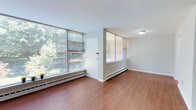Located at 7715 McCallum St in Philadelphia's charming Chestnut Hill neighborhood, this multi-story property spans three floors, offering a well-distributed and functional layout. The interior showcases warm hardwood flooring that flows throughout the living areas, contributing to a clean and inviting ambiance. Large windows with horizontal blinds allow an abundance of natural light to pour into the rooms, creating bright, airy spaces with pleasant views of the surrounding greenery. Baseboard heating units run along the perimeter of the rooms, ensuring comfortable year-round climate control. The walls are finished in a neutral white tone, providing a versatile backdrop that complements a variety of interior styles. The overall design is straightforward and practical, with clean lines and an open feel. The property's three floors provide ample vertical space, allowing for clear separation between living, sleeping, and utility areas. Situated in the desirable Chestnut Hill area, the property benefits from a lush, tree-lined setting that is visible through its expansive windows, blending the interior comfortably with the natural surroundings outside.