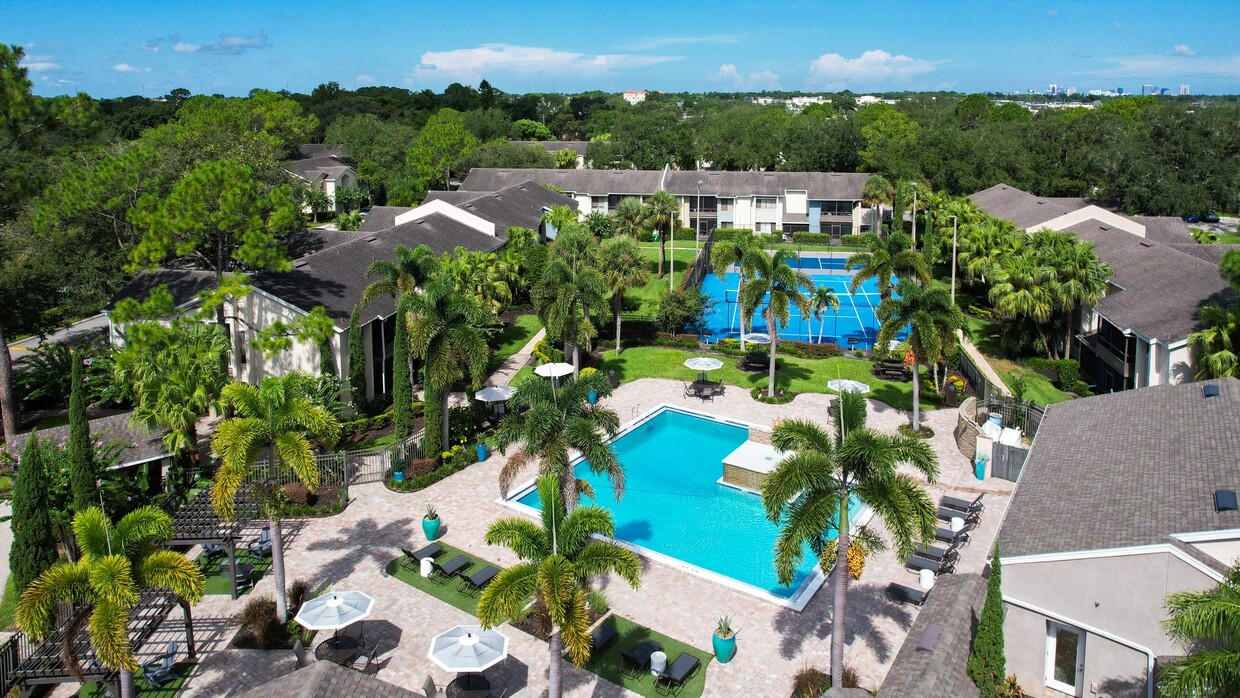 Enjoy our stunning pool area surrounded by lush landscaping and a beautiful tennis court, designed to provide a resort-style living experience. - Harper Grand