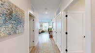 Located at 7220 Midlothian Turnpike in Richmond, VA, this 2-bedroom, 2-bathroom residence offers a thoughtfully designed single-floor layout that maximizes both comfort and functionality. A bright, welcoming entryway corridor with light wood-style flooring and crisp white walls leads into the heart of the home.

The open-concept kitchen and living area serves as the central gathering space. The kitchen features white shaker cabinetry, a subway tile backsplash, stainless steel appliances, a white quartz countertop, and a freestanding island with bar seating — ideal for casual dining. The living area flows seamlessly from the kitchen and is filled with natural light from large windows that frame outdoor views.

The primary bedroom is a comfortable retreat with plush carpeting, a ceiling fan, and direct access to a dedicated closet. Its en-suite bathroom is finished with white tile, a glass-enclosed walk-in shower, a single vanity with white cabinetry, and matte black fixtures throughout. The second bedroom offers a cozy, carpeted space with clean, neutral walls. The second full bathroom includes a tub-shower combination and coordinates with the same matte black hardware found elsewhere in the home.

Consistent light wood-style flooring, recessed lighting, and a neutral color palette unify the space, creating a modern yet inviting atmosphere throughout.