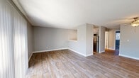 This newly renovated single-story home in Kent, Washington, offers 690 square feet of efficiently designed living space. The property features two bedrooms, including a primary bedroom of 130 square feet, and one bathroom. The open floor plan integrates the kitchen and living room, creating a spacious feel despite the modest square footage.

The interior boasts modern finishes throughout, with light gray walls complementing the durable wood-look flooring in the main living areas. Large windows and sliding glass doors flood the space with natural light, enhancing the sense of openness. The kitchen is equipped with stainless steel appliances, white cabinetry, and ample counter space, making it both functional and visually appealing.

Both bedrooms feature plush carpeting and generous closet space. The bathroom, while compact, is pristine with a white color scheme and a shower-tub combination. Energy-efficient features include a programmable thermostat and ceiling fans.

Located at 23818 111th Pl SE in Kent, this home offers a blend of modern comfort and practicality, ideal for first-time homebuyers, small families, or those looking to downsize without sacrificing quality. The property's layout and updates make excellent use of its 690 square feet, providing a cozy yet contemporary living environment.