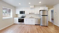 Located at 607 47th St SE in Everett, WA, this ground-floor unit offers a thoughtfully designed 2-bedroom, 2-bathroom layout across a single level. Light wood-tone luxury vinyl flooring runs consistently throughout the space, creating a cohesive and clean aesthetic. The kitchen is a standout feature, showcasing white shaker-style cabinetry, light quartz countertops, recessed lighting, and a full suite of stainless steel appliances including a range, microwave, dishwasher, and refrigerator. Both bedrooms are bright and inviting, each featuring sliding-door closets and windows fitted with blinds that invite natural light while maintaining privacy. The neutral, warm-toned walls complement the light flooring for a calm and versatile ambiance. Both bathrooms continue the modern design language with white vanity cabinetry, quartz-style countertops, and brushed nickel fixtures. The primary bathroom includes an en-suite layout accessible directly from the bedroom corridor. Throughout the unit, clean white trim and recessed lighting add a polished, move-in-ready feel. The overall design is functional, contemporary, and well-suited for comfortable everyday living.