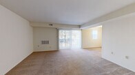 Located at 2012 Kelbourne Rd in Rosedale, Maryland, this single-floor, two-bedroom, one-and-a-half-bath residence offers a practical and comfortable layout suited for a range of lifestyles. The open living and dining area is generously proportioned, featuring wall-to-wall carpeting in a neutral tan tone and a large sliding glass door fitted with vertical blinds that allows natural light to fill the space while providing access to an outdoor balcony. An adjacent area, distinguished by its warm yellow accent wall, extends the living space and benefits from an additional window.

The kitchen is well-appointed with rich dark-wood cabinetry, light countertops, stainless steel appliances including a gas range, dishwasher, and an under-cabinet range hood, all set atop light marble-style tile flooring.

Both bedrooms are carpeted and feature closet storage — one with a walk-in closet with shelving, the other with a bifold-door closet. Each room receives natural light through windows with vertical blinds.

The bathrooms are finished with mosaic tile flooring, white vanities, and tiled surrounds. The full bath includes a tub-shower combination, while the half bath offers a vanity and toilet. The overall ambiance is clean, neutral, and move-in ready.