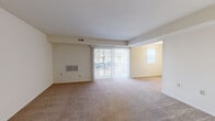 Located at 2012 Kelbourne Rd in Rosedale, Maryland, this single-floor, two-bedroom, one-and-a-half-bath residence offers a practical and comfortable layout suited for a range of lifestyles. The open living and dining area is generously proportioned, featuring wall-to-wall carpeting in a neutral tan tone and a large sliding glass door fitted with vertical blinds that allows natural light to fill the space while providing access to an outdoor balcony. An adjacent area, distinguished by its warm yellow accent wall, extends the living space and benefits from an additional window.

The kitchen is well-appointed with rich dark-wood cabinetry, light countertops, stainless steel appliances including a gas range, dishwasher, and an under-cabinet range hood, all set atop light marble-style tile flooring.

Both bedrooms are carpeted and feature closet storage — one with a walk-in closet with shelving, the other with a bifold-door closet. Each room receives natural light through windows with vertical blinds.

The bathrooms are finished with mosaic tile flooring, white vanities, and tiled surrounds. The full bath includes a tub-shower combination, while the half bath offers a vanity and toilet. The overall ambiance is clean, neutral, and move-in ready.