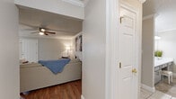 Located at 3661 Airport Blvd in Mobile, Alabama, this single-story 2-bedroom, 3-bathroom home offers a thoughtfully designed layout across a comfortable footprint. Crown molding is a consistent architectural detail throughout, lending a polished character to each room.

The living room features hardwood flooring, a ceiling fan, and crown molding, creating a welcoming and well-finished gathering space. Adjacent, the dining room offers tile flooring, a large window with natural light, wainscoting, and a pendant light overhead—ideal for everyday dining.

The kitchen is outfitted with white cabinetry, light granite countertops, stainless steel appliances, a gold-tone sink faucet, and tile flooring, providing a clean and functional workspace. A dedicated laundry area and utility room add practical convenience.

The spacious primary bedroom features plush carpeting, a ceiling fan, crown molding, and a generously sized walk-in closet with wire shelving on multiple levels. Its en-suite bathroom includes a dual-sink vanity with an extended countertop, tile flooring, and a bright, well-lit mirror. The second bedroom is equally comfortable, also featuring carpeting and a ceiling fan. Four closets throughout the home ensure ample storage. The overall ambiance is neutral, bright, and move-in ready.