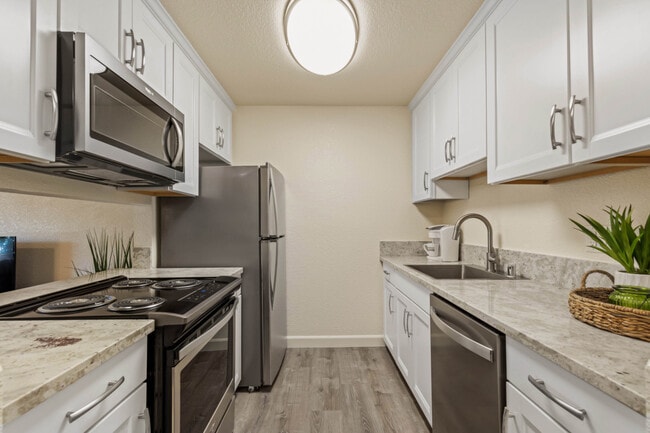 Deluxe Kitchen with Soft close Cabinets, Sleek Stainless Steel Appliances, & Granite Countertops - One Month Free Aggie Square Apartments