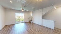 Located at 500 Roseville Parkway in Roseville, CA, this three-bedroom, three-bathroom multi-story home is thoughtfully laid out across three floors. The ground level houses a spacious attached garage with a paneled door, overhead opener, and bright overhead lighting — offering generous room for vehicles and storage. The main living level serves as the heart of the home, featuring an open-concept kitchen and living room with light hardwood-style flooring throughout. The kitchen is equipped with dark espresso cabinetry, white quartz countertops, stainless steel appliances including a refrigerator and dishwasher, and a central island for additional prep space. The adjacent living area is bright and airy, highlighted by recessed lighting, a ceiling fan, and sliding glass doors that open to a private balcony with neighborhood views. A convenient half bathroom is also found on this floor. The upper level hosts all three bedrooms, each carpeted and filled with natural light from windows overlooking the surrounding community. The primary bedroom includes a walk-in closet with built-in shelving. The bathrooms are finished with white countertops, dark wood vanities, and clean, modern fixtures. Two staircases connect the floors, ensuring smooth circulation throughout the home.